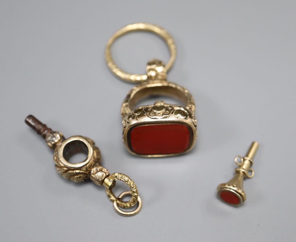 A 19th century gold-cased fob seal with uncut carnelian matrix, a 19th century gold watch key and a gold-cased watch key